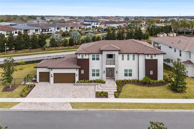 view of front of property featuring a garage and a front lawn