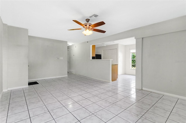 spare room featuring ceiling fan and light tile patterned flooring