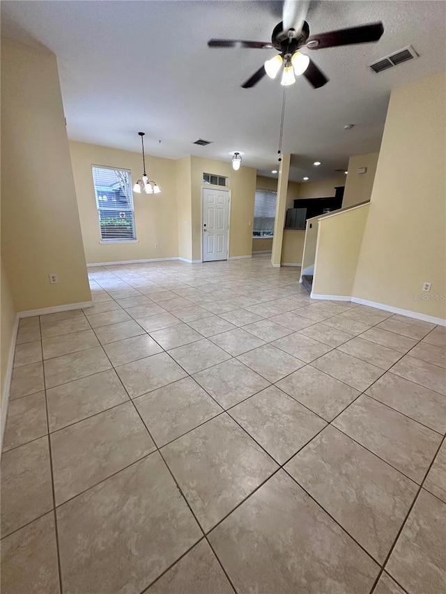 6430 S Goldenrod Rd Unit 15B, Orlando, FL 32822 - unfurnished living room with light tile patterned floors, a chandelier, a ceiling fan, and baseboards