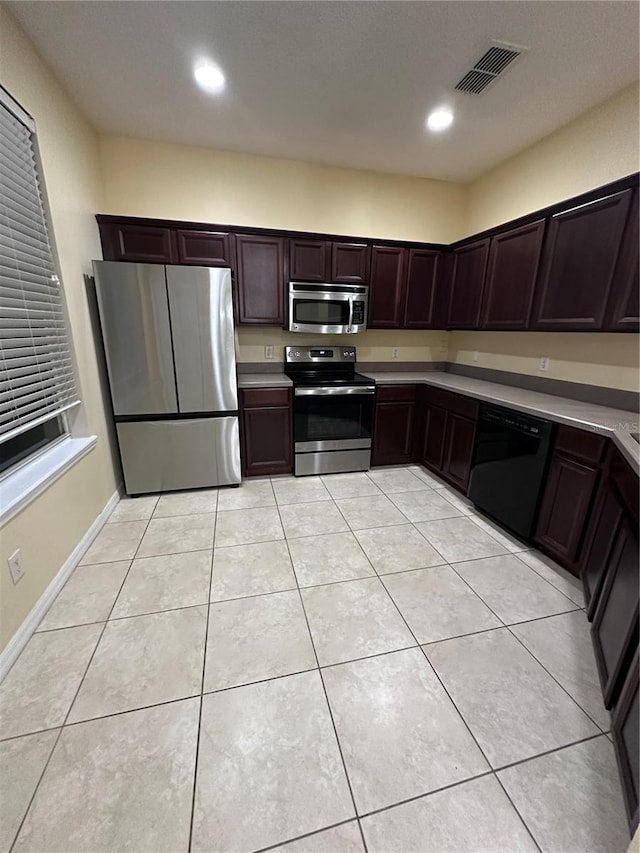 6430 S Goldenrod Rd Unit 15B, Orlando, FL 32822 - kitchen featuring appliances with stainless steel finishes, dark brown cabinets, light countertops, light tile patterned floors, and recessed lighting
