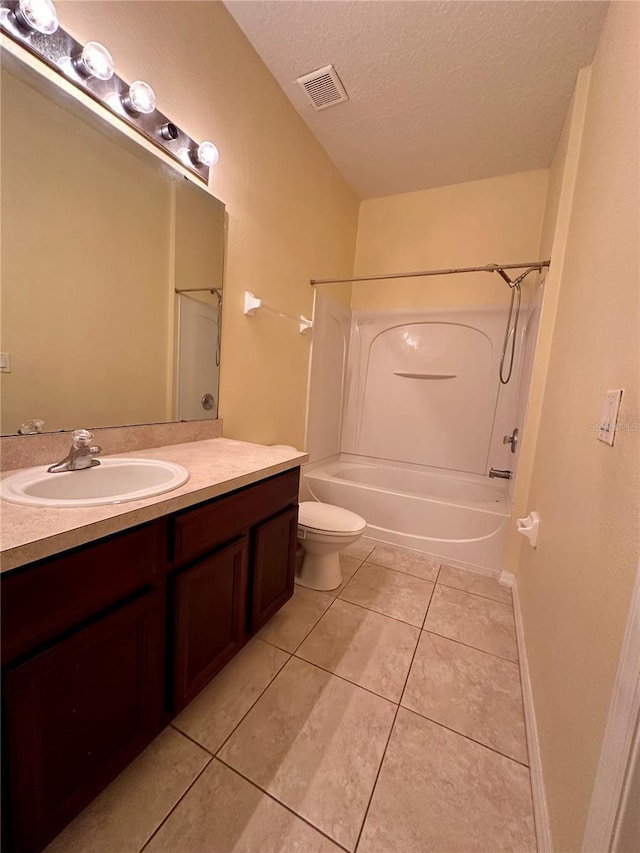 6430 S Goldenrod Rd Unit 15B, Orlando, FL 32822 - bathroom with a textured ceiling, vanity, bathtub / shower combination, tile patterned floors, and toilet
