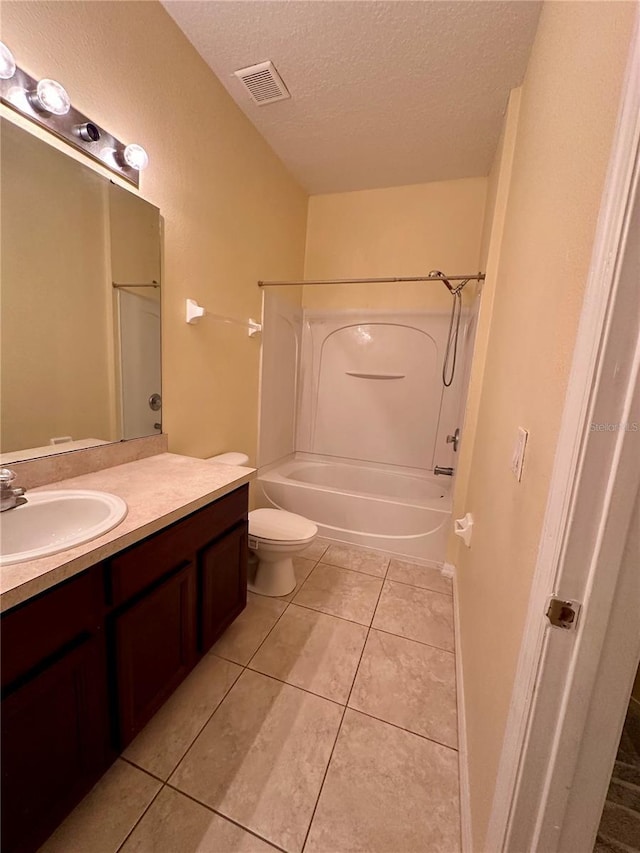 6430 S Goldenrod Rd Unit 15B, Orlando, FL 32822 - bathroom featuring vanity, a textured ceiling, shower / bath combination, tile patterned flooring, and toilet