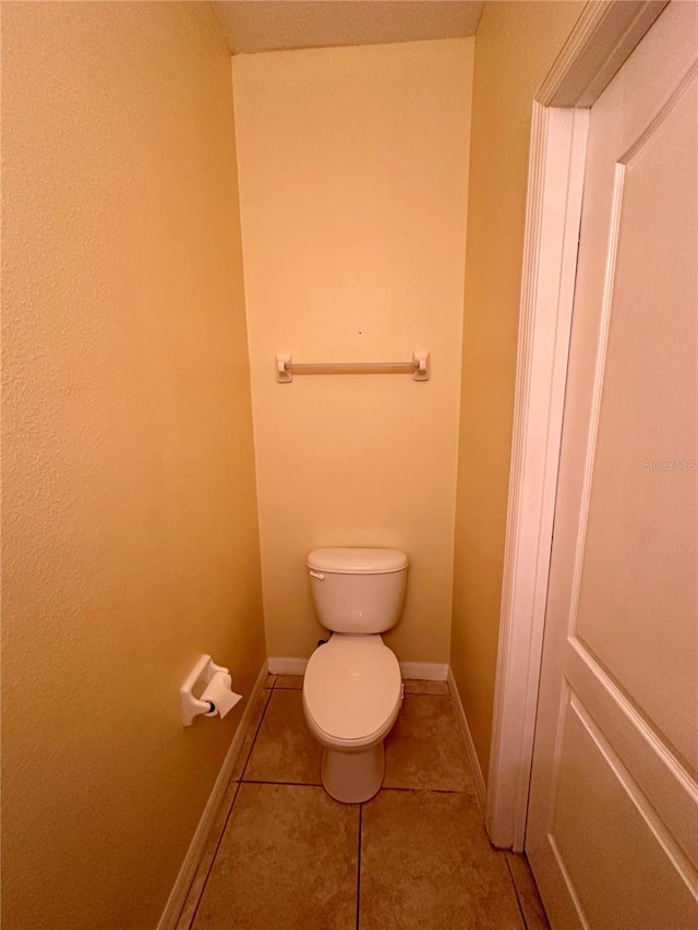 6430 S Goldenrod Rd Unit 15B, Orlando, FL 32822 - bathroom featuring toilet, tile patterned flooring, and baseboards