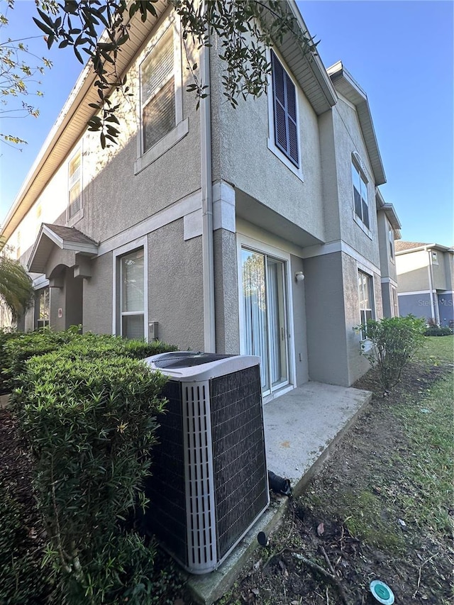 6430 S Goldenrod Rd Unit 15B, Orlando, FL 32822 - rear view of property featuring central AC unit and stucco siding