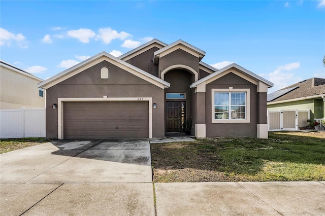 view of front of home featuring a garage and a front yard