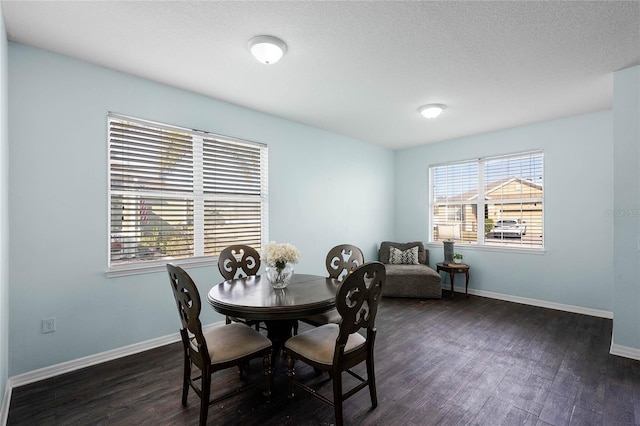 dining room featuring dark hardwood / wood-style floors and a textured ceiling