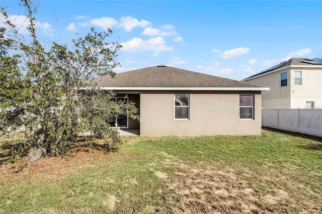 rear view of house with a lawn