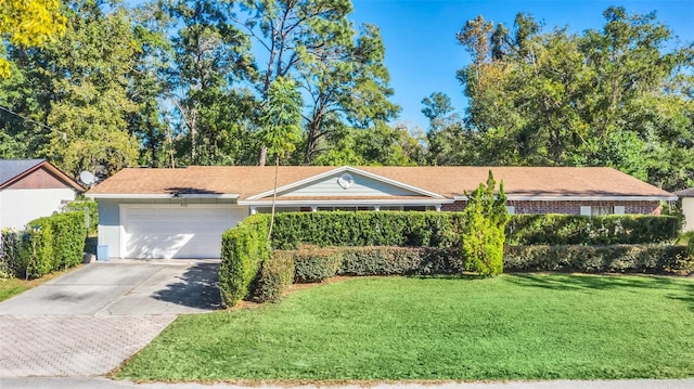 ranch-style home with a garage and a front lawn