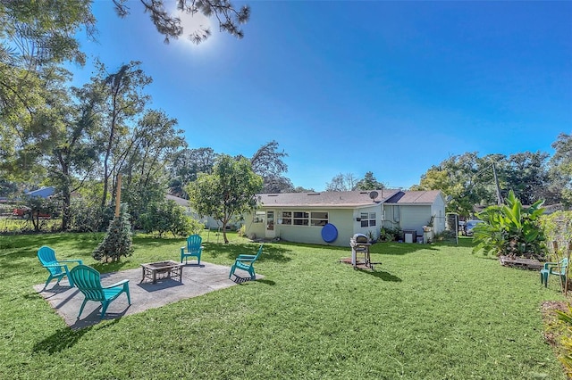 view of yard featuring a patio area and an outdoor fire pit