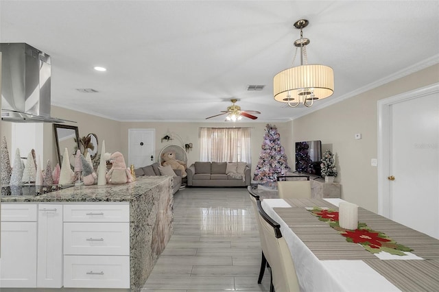 kitchen featuring light stone counters, black electric cooktop, ceiling fan, decorative light fixtures, and white cabinetry