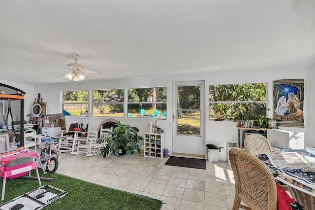 sunroom featuring ceiling fan