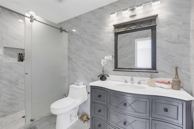 bathroom with vanity, toilet, tiled shower, and tile walls