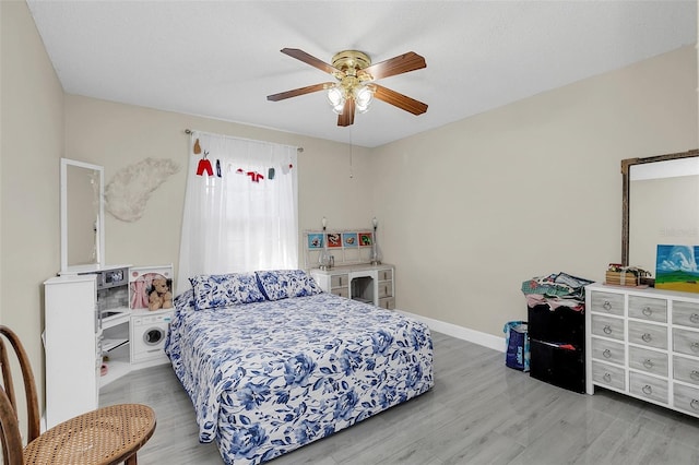 bedroom with light wood-type flooring and ceiling fan