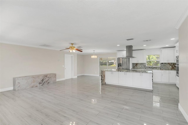 unfurnished living room with crown molding and ceiling fan