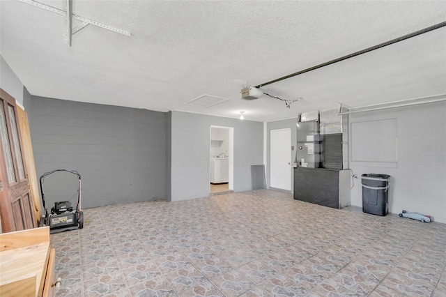 garage with washer / clothes dryer, heating unit, and a garage door opener