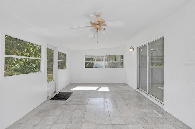 unfurnished sunroom featuring ceiling fan