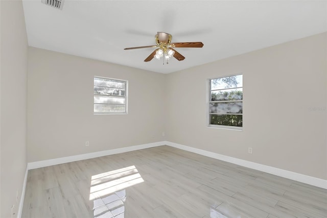 spare room featuring ceiling fan and light hardwood / wood-style floors