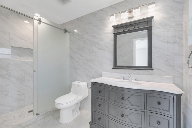 bathroom featuring walk in shower, vanity, toilet, and tile walls