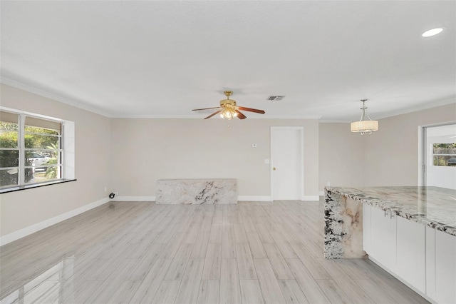 empty room featuring ceiling fan, ornamental molding, and light hardwood / wood-style flooring