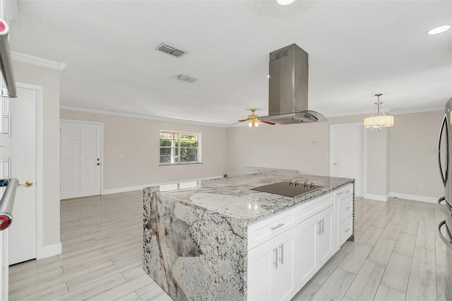 kitchen with white cabinetry, light stone counters, hanging light fixtures, black electric cooktop, and island exhaust hood