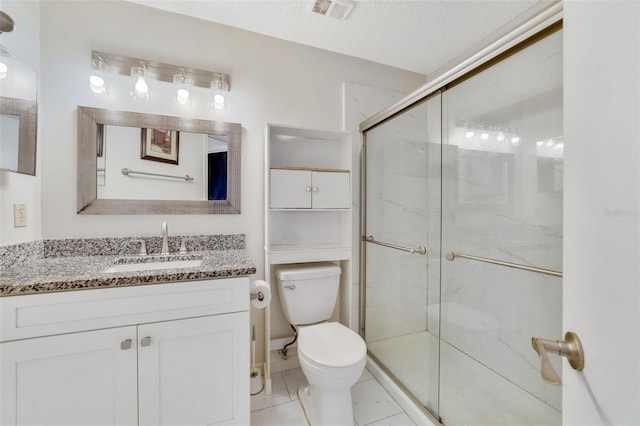 bathroom with visible vents, toilet, a stall shower, a textured ceiling, and vanity