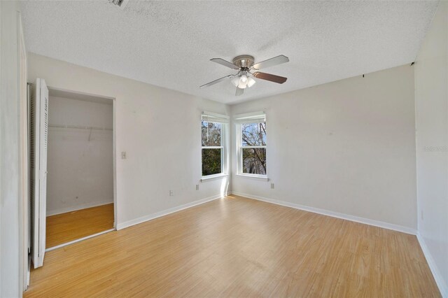 unfurnished bedroom with light wood-style floors, a closet, and baseboards