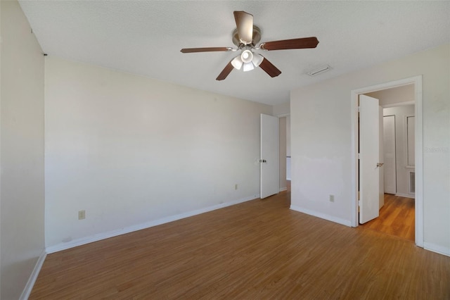 unfurnished bedroom featuring baseboards, wood finished floors, and a ceiling fan