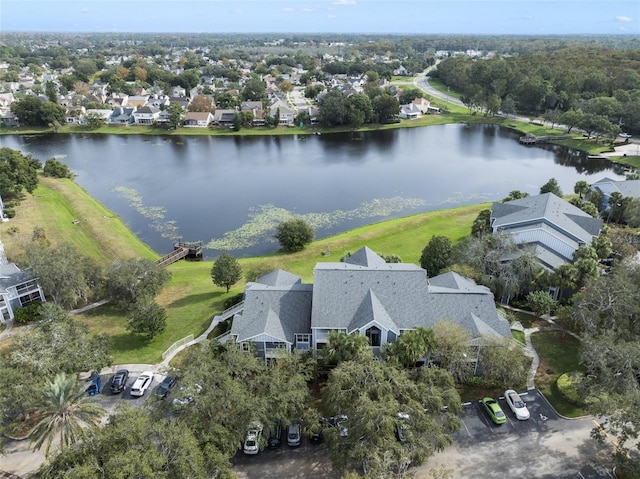 drone / aerial view featuring a residential view and a water view