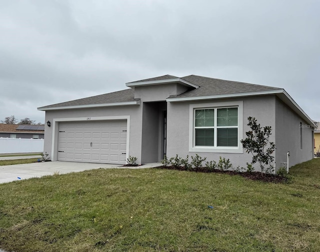 view of front of home featuring a garage and a front yard