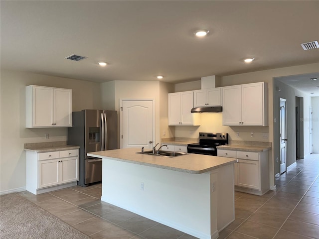 kitchen featuring white cabinetry, tile patterned floors, stainless steel appliances, sink, and a center island with sink