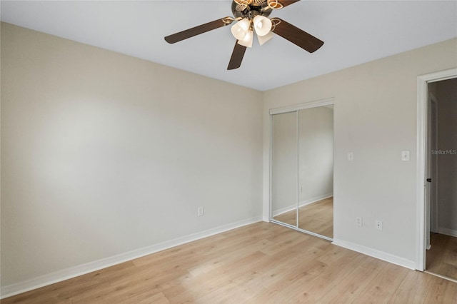 unfurnished bedroom with a closet, light hardwood / wood-style floors, and ceiling fan