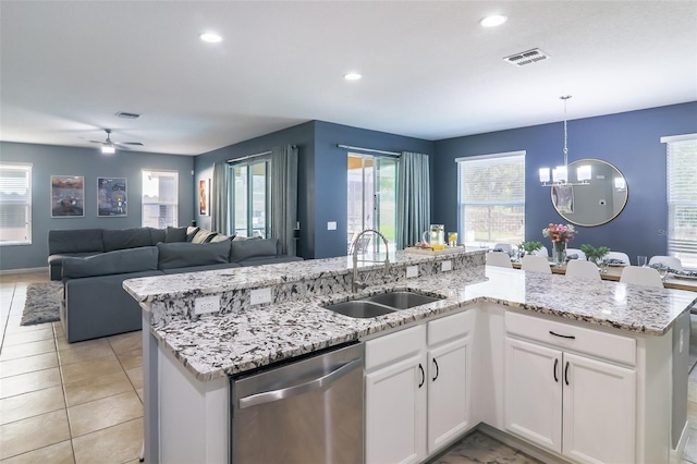 kitchen featuring pendant lighting, white cabinetry, stainless steel dishwasher, and sink