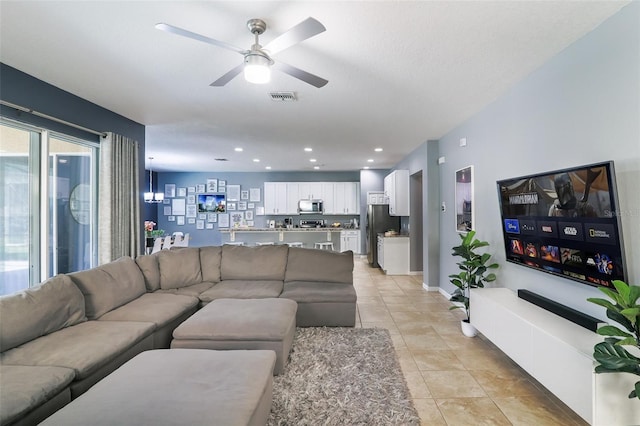 tiled living room with ceiling fan