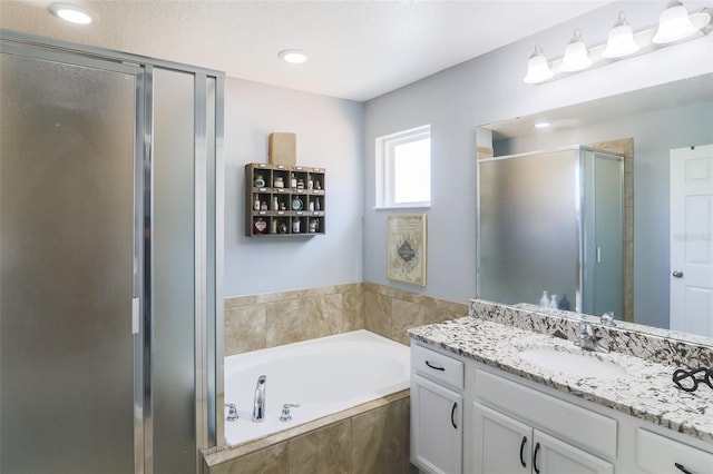 bathroom with separate shower and tub and vanity