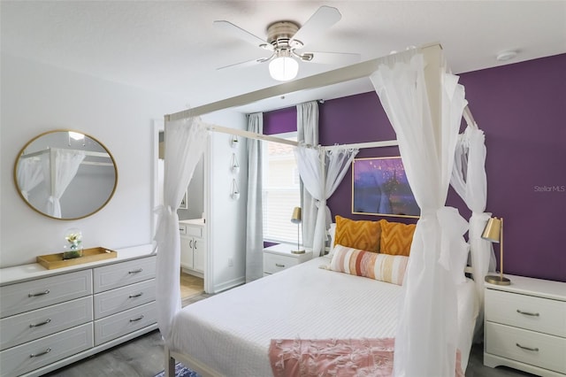 bedroom with ceiling fan, light wood-type flooring, and ensuite bathroom