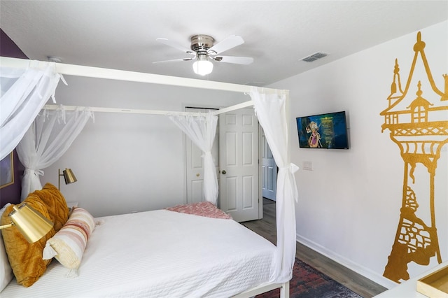 bedroom with ceiling fan and dark hardwood / wood-style floors