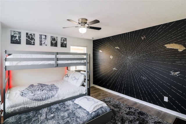 bedroom with dark hardwood / wood-style floors and ceiling fan