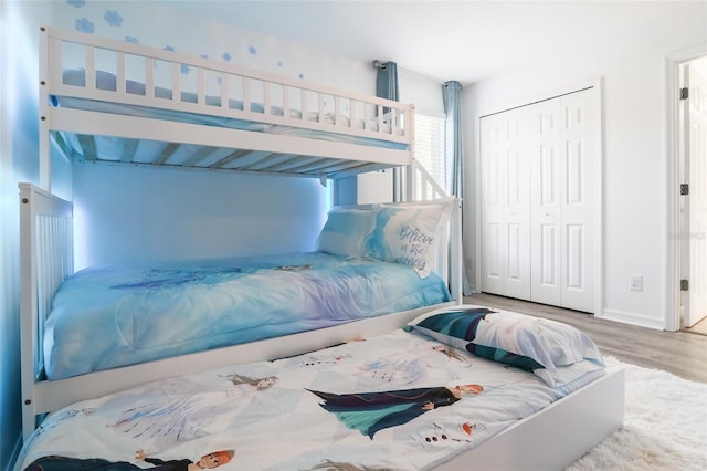 bedroom featuring hardwood / wood-style flooring and a closet