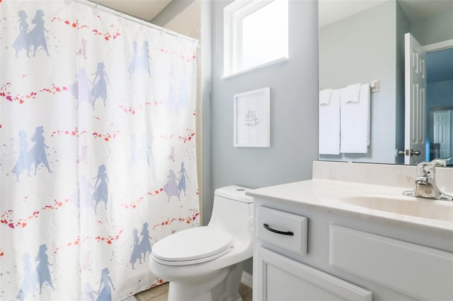 bathroom with vanity, toilet, and curtained shower