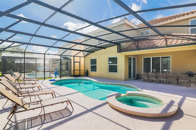 view of swimming pool with a lanai, an in ground hot tub, and a patio