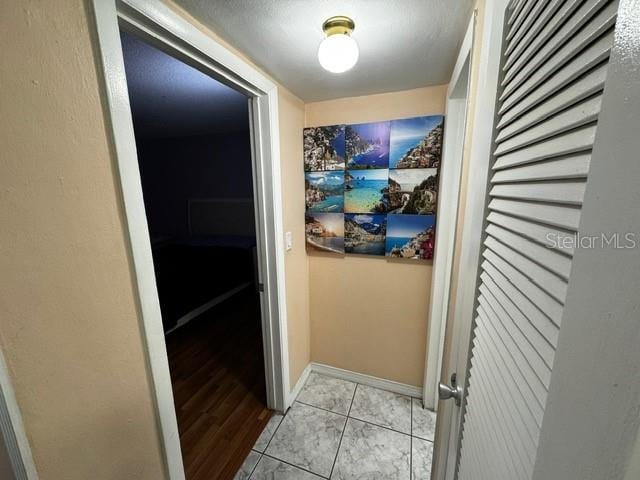 hallway featuring light tile patterned floors