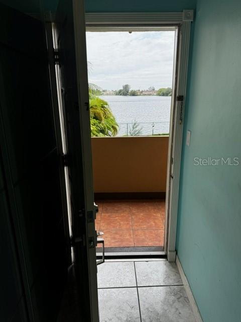 entryway with a water view and light tile patterned floors