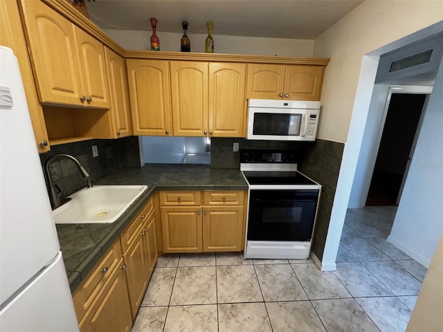 kitchen featuring light tile patterned floors, white appliances, a sink, visible vents, and decorative backsplash