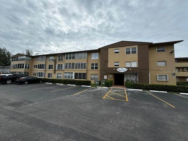 view of property featuring uncovered parking