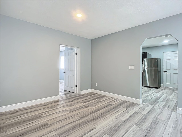 unfurnished room with light hardwood / wood-style flooring