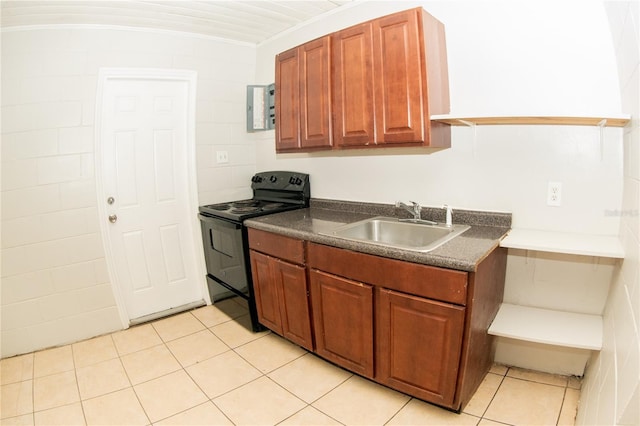 kitchen featuring sink, electric range, light tile patterned floors, tile walls, and ornamental molding