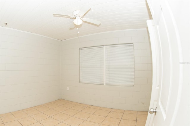 tiled empty room with ceiling fan and crown molding