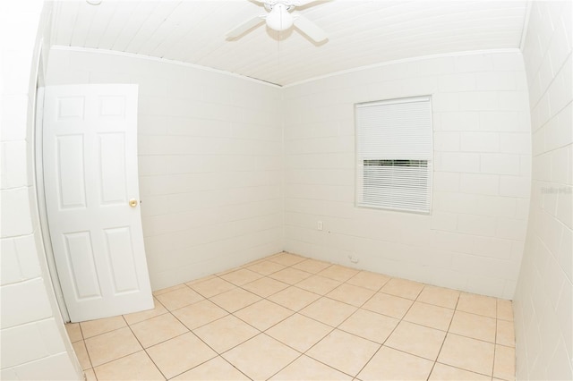 empty room with ceiling fan and light tile patterned floors