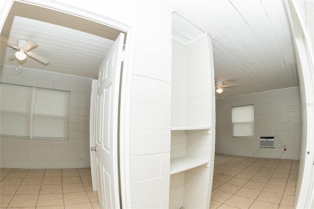 bathroom featuring tile patterned flooring, a wall unit AC, and ceiling fan