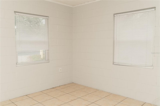 tiled empty room with a healthy amount of sunlight